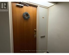 A brown door with a wreath on it.