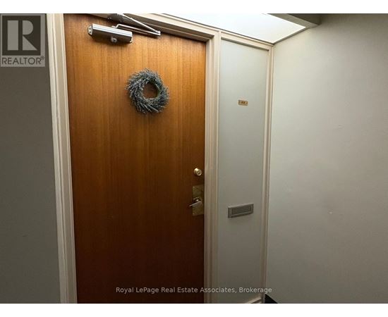 A brown door with a wreath on it.