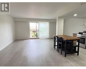 A dining room with a wooden table and chairs.