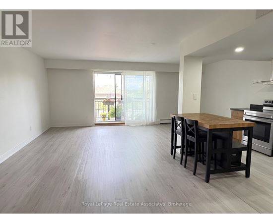 A dining room with a wooden table and chairs.