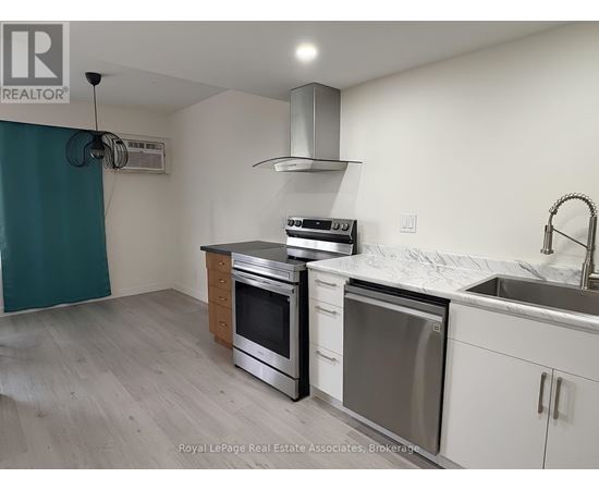 A kitchen with white cabinets and stainless steel appliances.