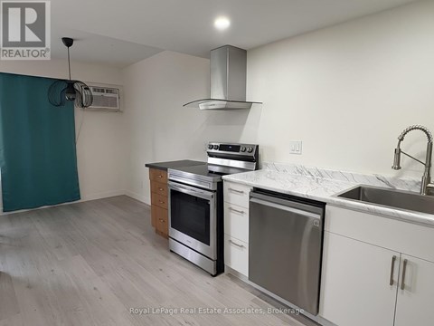 A kitchen with white cabinets and stainless steel appliances.