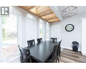 A dining room with a table and chairs.