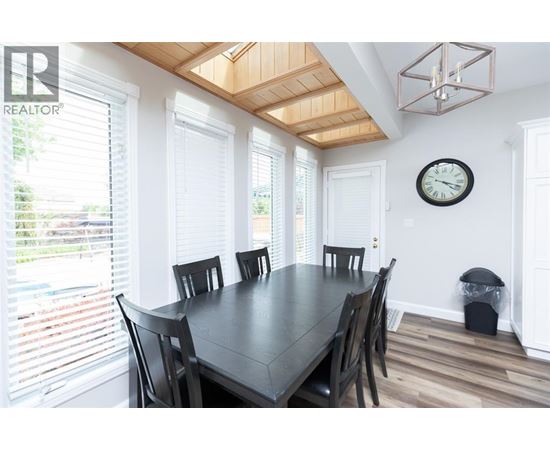 A dining room with a table and chairs.