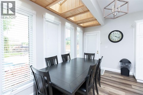 A dining room with a table and chairs.