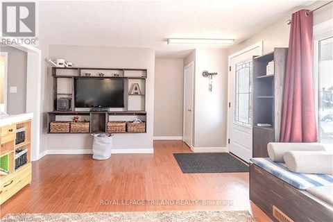 A living room with a television and a couch.