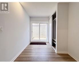 A hallway with a window and a door on the right.