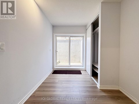 A hallway with a window and a door on the right.