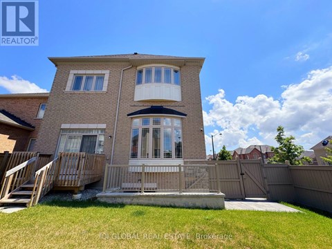 A house with a brown brick exterior and a white balcony.