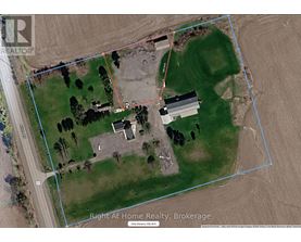 A satellite image of a property with a house and a fenced area.
