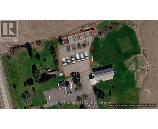 An aerial view of a property with a parking lot and buildings.