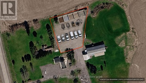 An aerial view of a property with a parking lot and buildings.