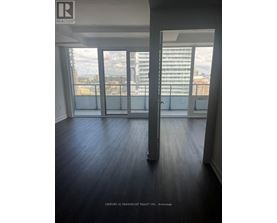A room with a view of the city through large windows.