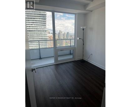 A room with a large window overlooking a cityscape.
