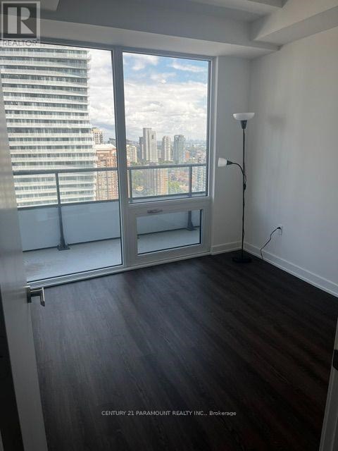 A room with a large window overlooking a cityscape.