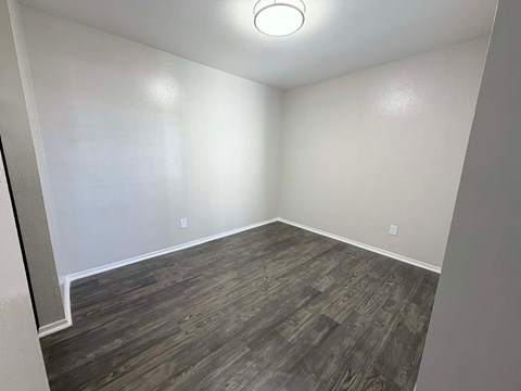 A room with a grey floor and a white wall.