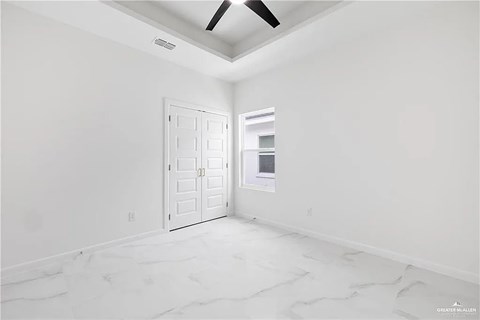 A room with a white door and a window with a white frame.