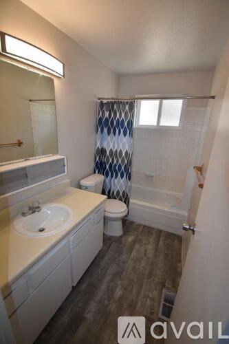 A bathroom with a toilet, sink, and shower.