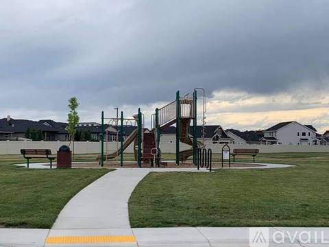 A playground with a slide and a yellow caution line on the ground.