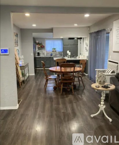 A kitchen with a table and chairs in the middle of the room.