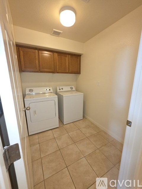 A small laundry room with a washer and dryer.