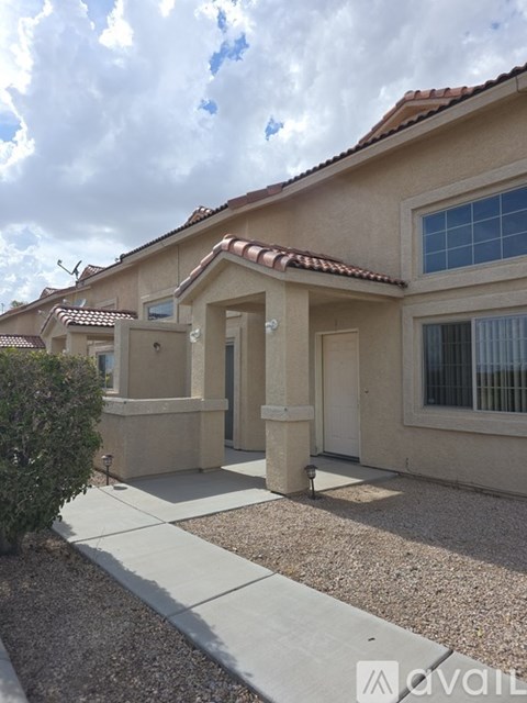 A house with a brown roof and a white door is shown.