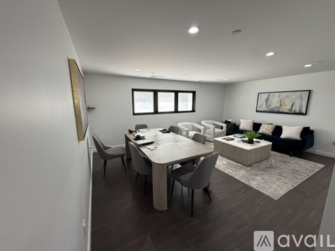 A modern dining room with a large table and chairs.