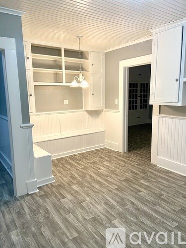 A room with a grey floor and white walls.