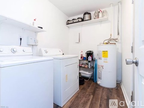 A small laundry room with a washer and dryer.