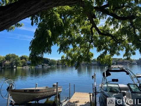 A boat is docked at a pier on a lake.
