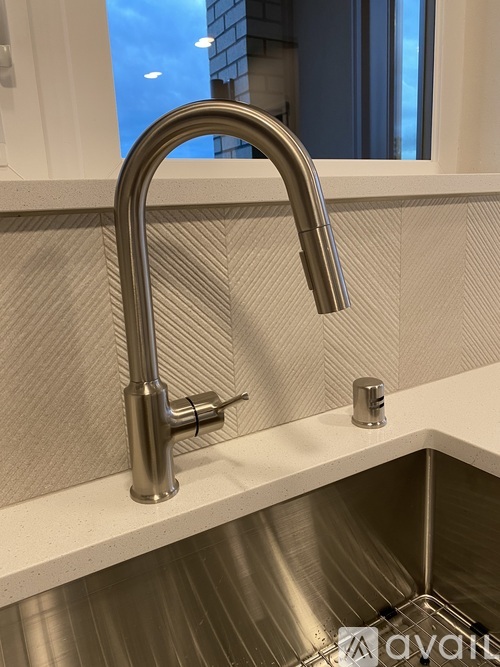 A chrome kitchen faucet with a pull out sprayer.