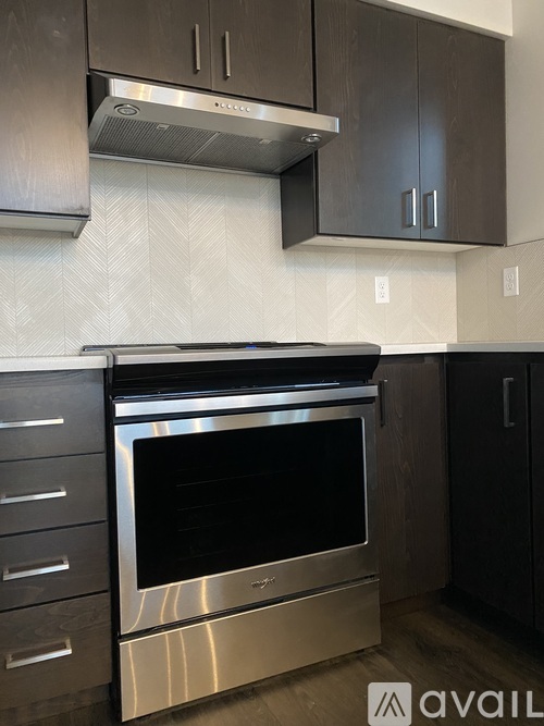 A modern kitchen with a stainless steel oven and cabinets.