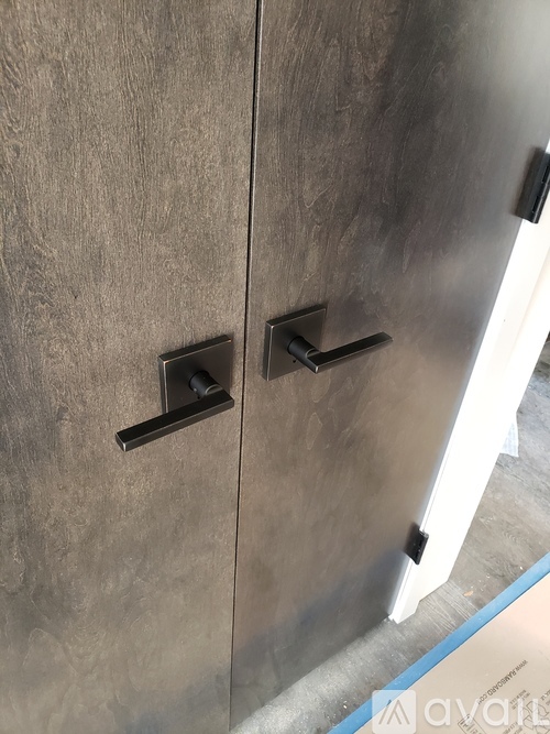 A metal cabinet with two black handles.