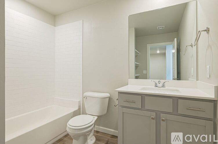 A bathroom with a toilet, sink, and bathtub.