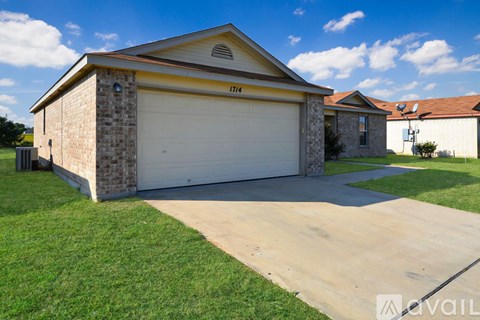 A two-car garage with a brick exterior and a brown roof.