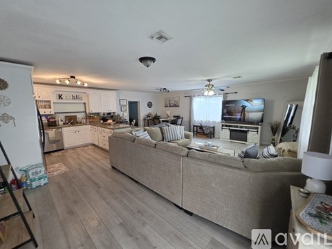 A living room with a couch and a television.