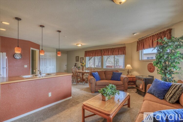 A living room with a brown couch and a wooden coffee table.