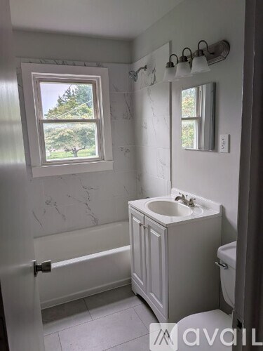 A bathroom with a window and a sink.