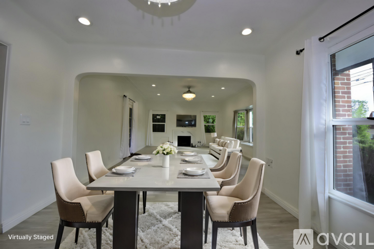 A dining room with a table set for six people.