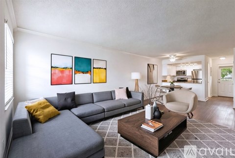 A living room with a grey couch and a coffee table.