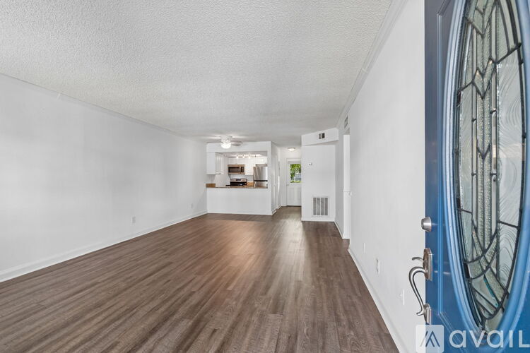 A room with wooden flooring and a blue door.