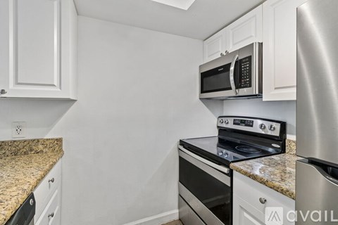 A kitchen with a stove top oven and microwave.