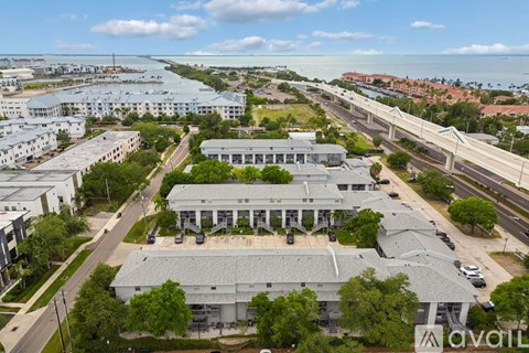 A large building complex with a parking lot in front of it.