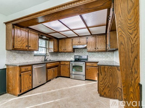 A kitchen with wooden cabinets and stainless steel appliances.