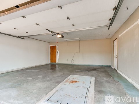 A room with a concrete floor and a wooden door.