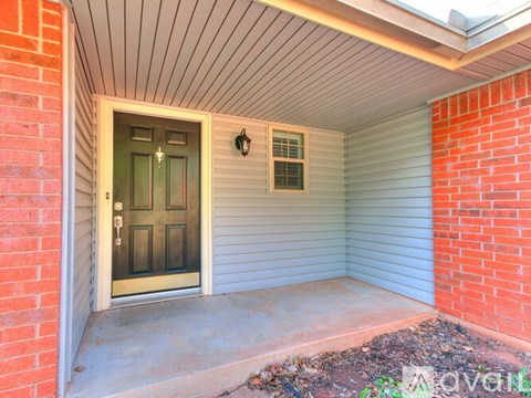 A front door with a sidelight and a small window above it.