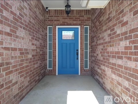 A blue door is set in a brick wall.