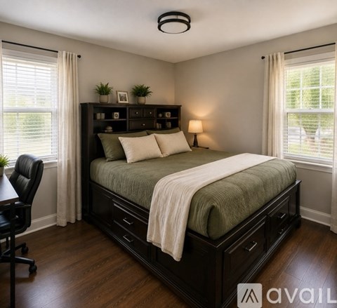 A bedroom with a large bed and a desk.