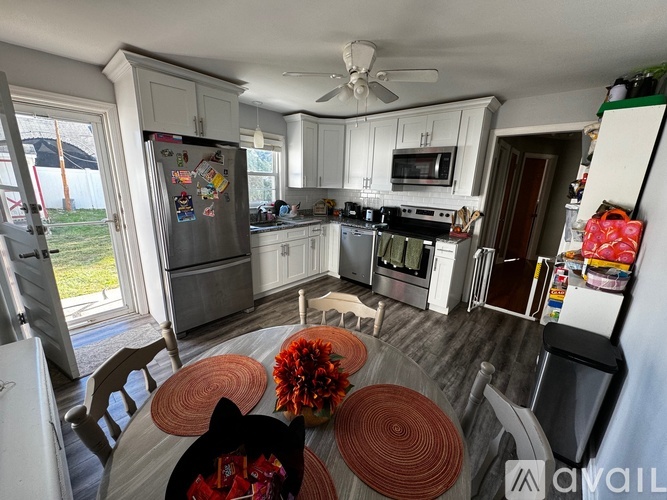 A kitchen with a table and chairs in the middle of it.
