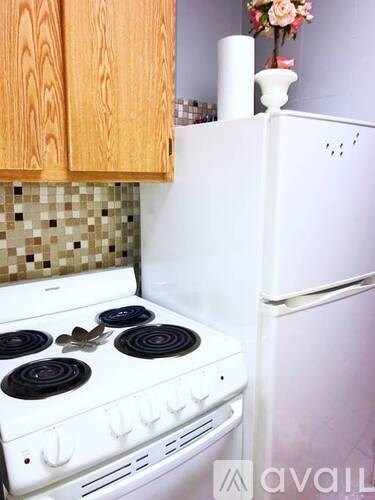 A white stove and refrigerator in a kitchen.